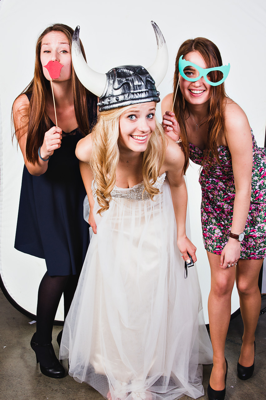 Three women smiling in a photo booth